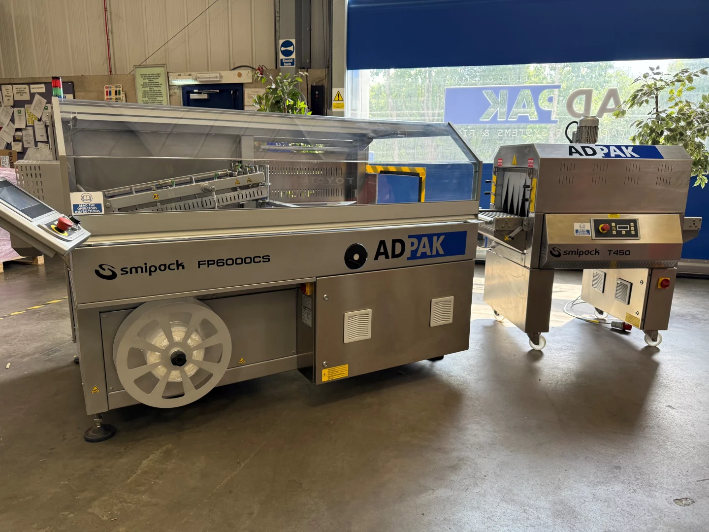 Adpak Automatic L-Sealer with T450 INOX Heat Shrink Tunnel for high-speed packaging.